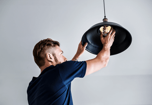Electrician Installing Light Bulb